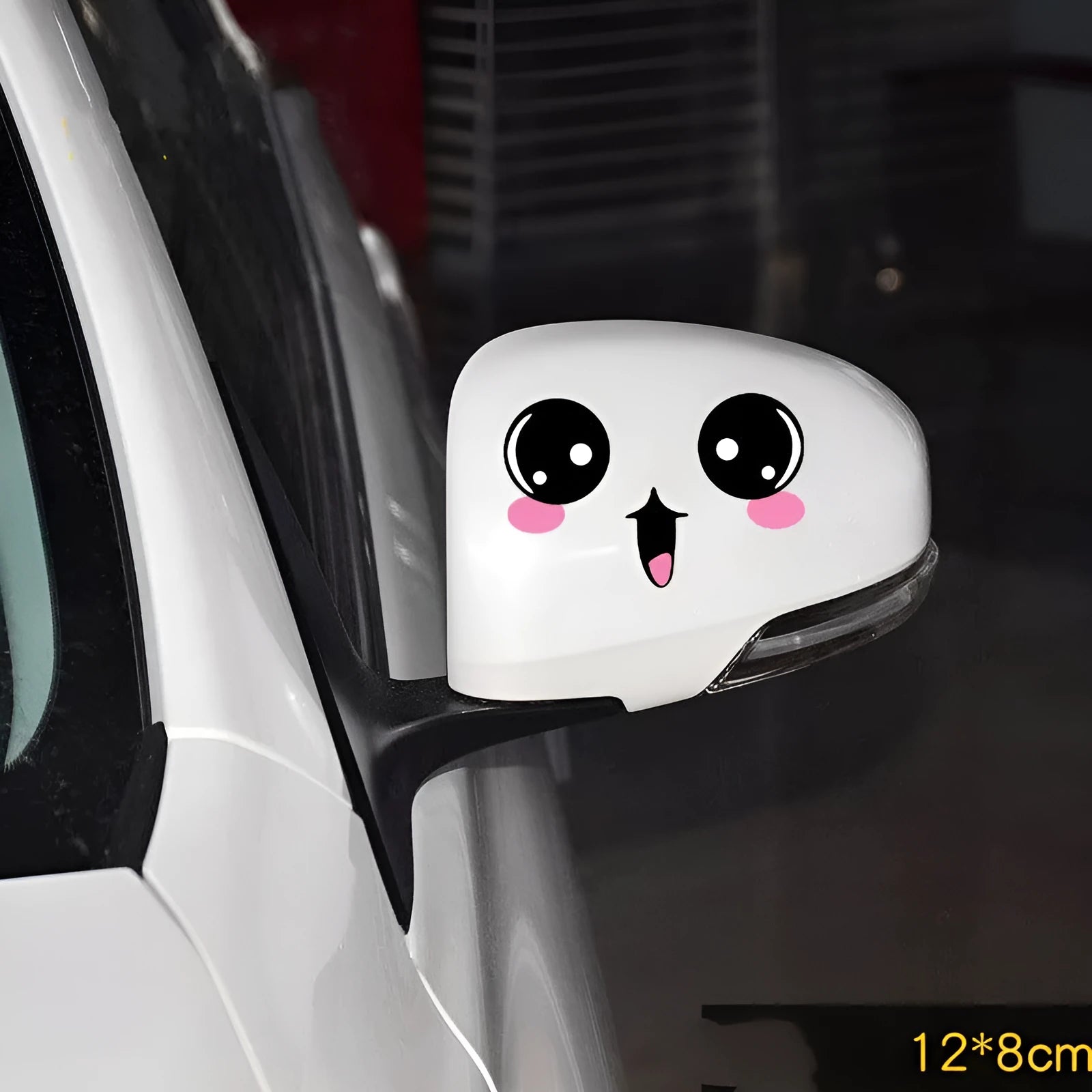 Pair of reflective cartoon car stickers with cute eyes on a car rearview mirror.