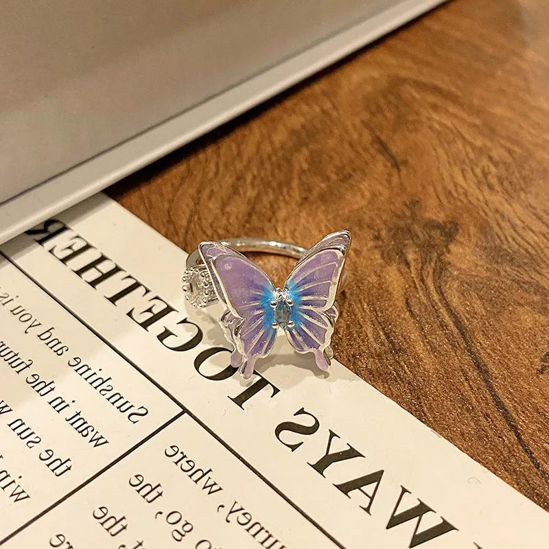 Creative butterfly design women's ring in copper with oil drip finish, showing an open loop style.