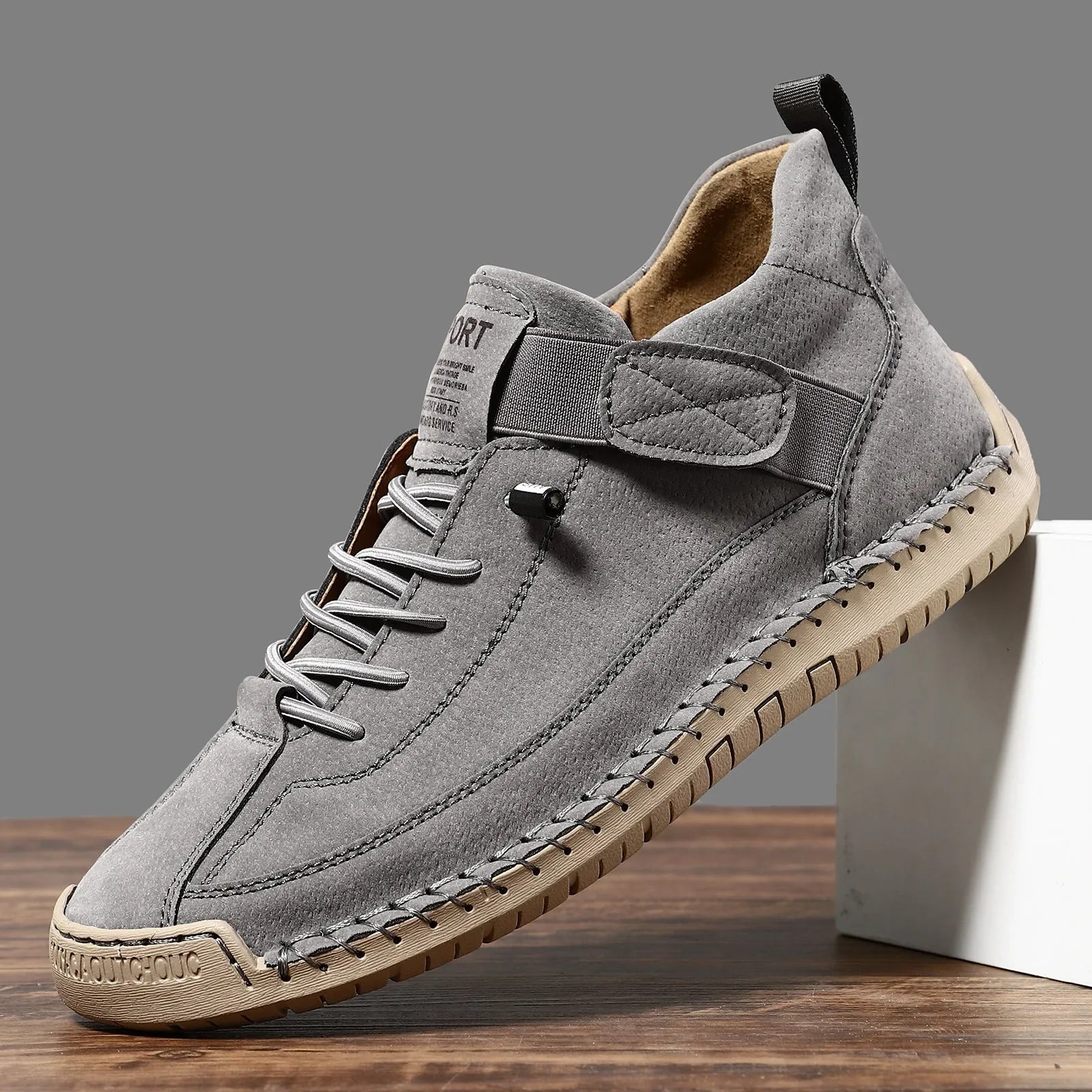 Men's mid-calf Martin boots in khaki with visible tooling stitching and an elastic band across the instep.