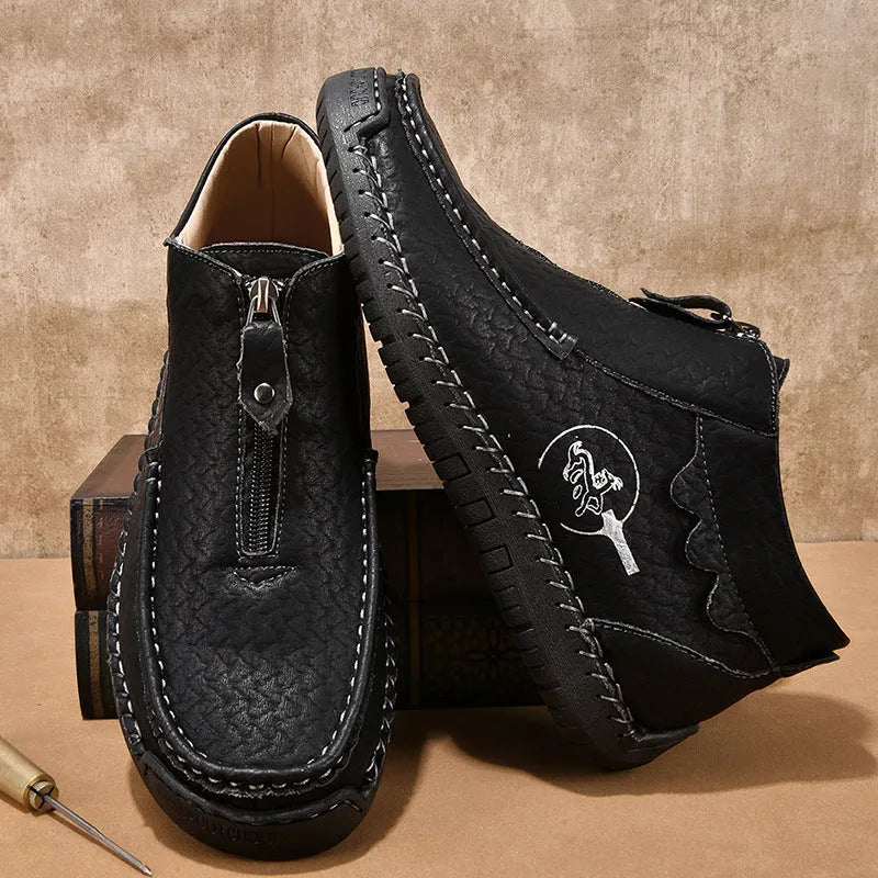 Men's black slip-on leather loafers with round toe and rubber sole, displayed on a white background.