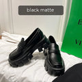 British style wide-fit patent leather loafers with a distinctive muffin heel on a rubber sole.