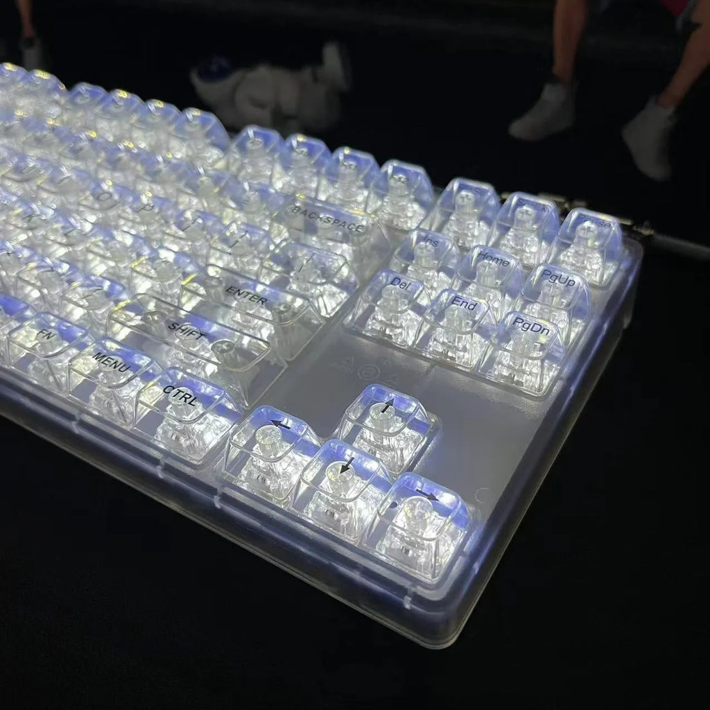 Universal transparent plastic 132-key keyboard key cap set laid out on a table.
