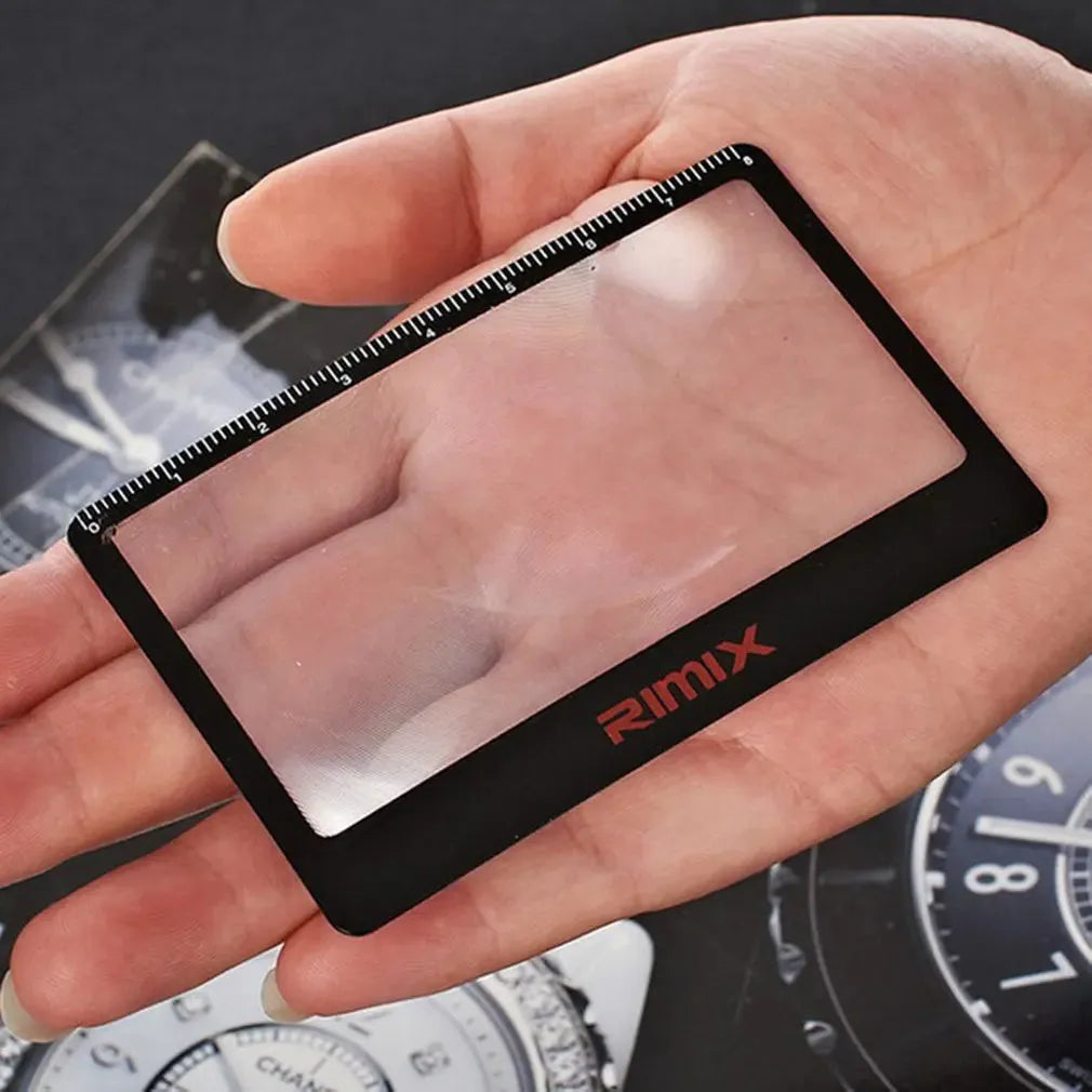 Black and white portable credit card sized foldable plastic magnifier for reading small text.