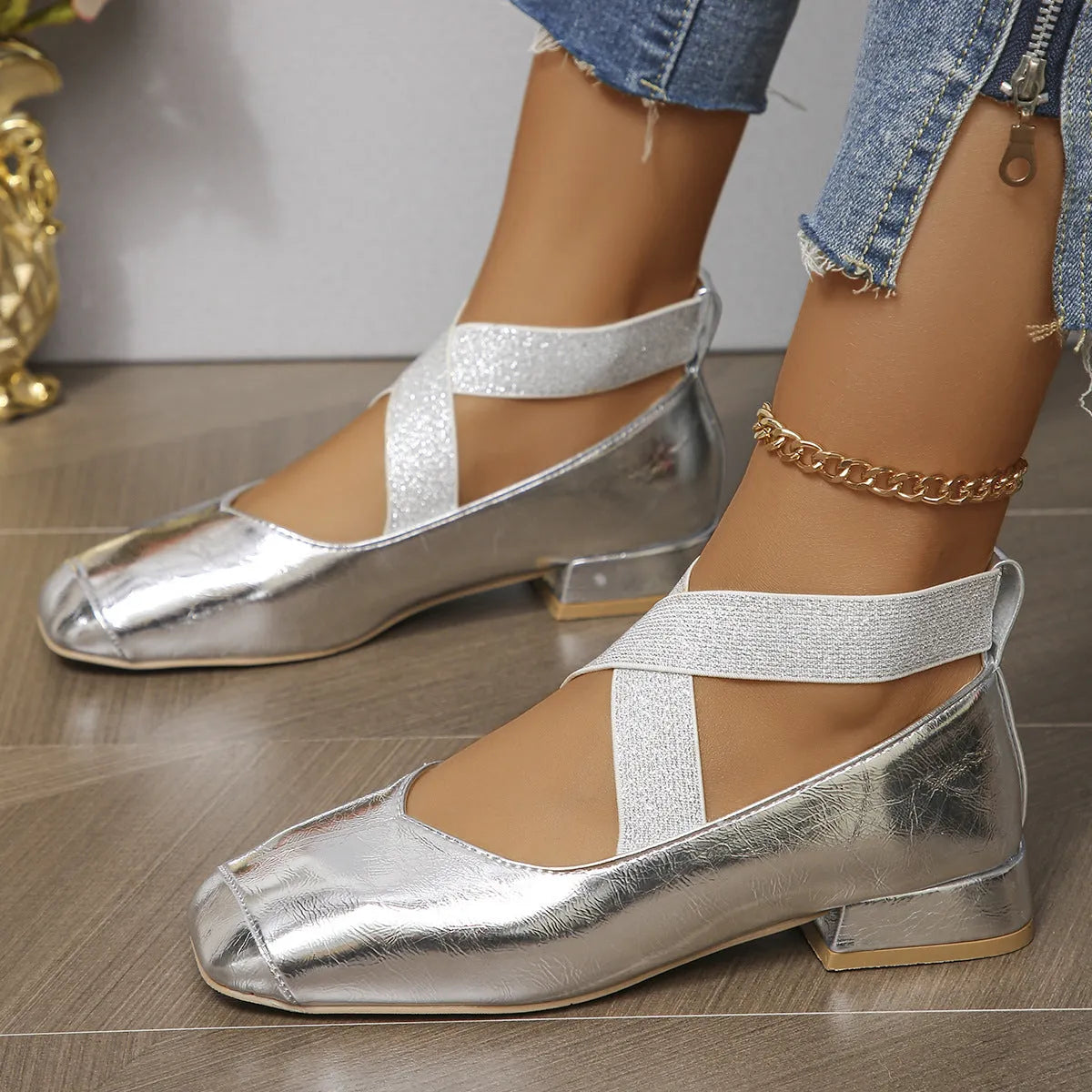 Gold women's slip-on evening pumps with skirt detail, square toe, and low rubber heel