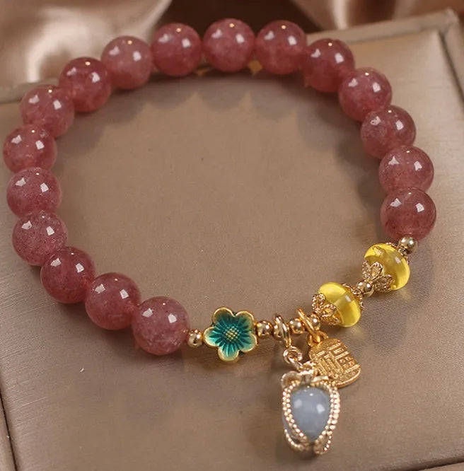 Red adjustable bracelet with strawberry quartz beads, alloy charm and rhinestone detailing