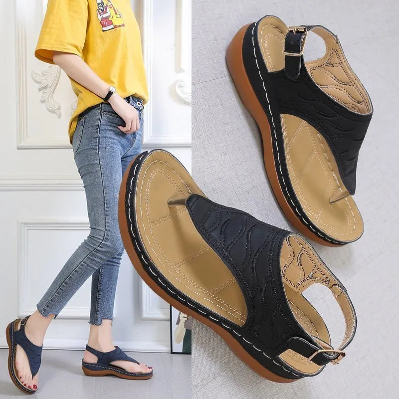 Women's black casual wedge heel flip flop sandals with an adjustable buckle strap.