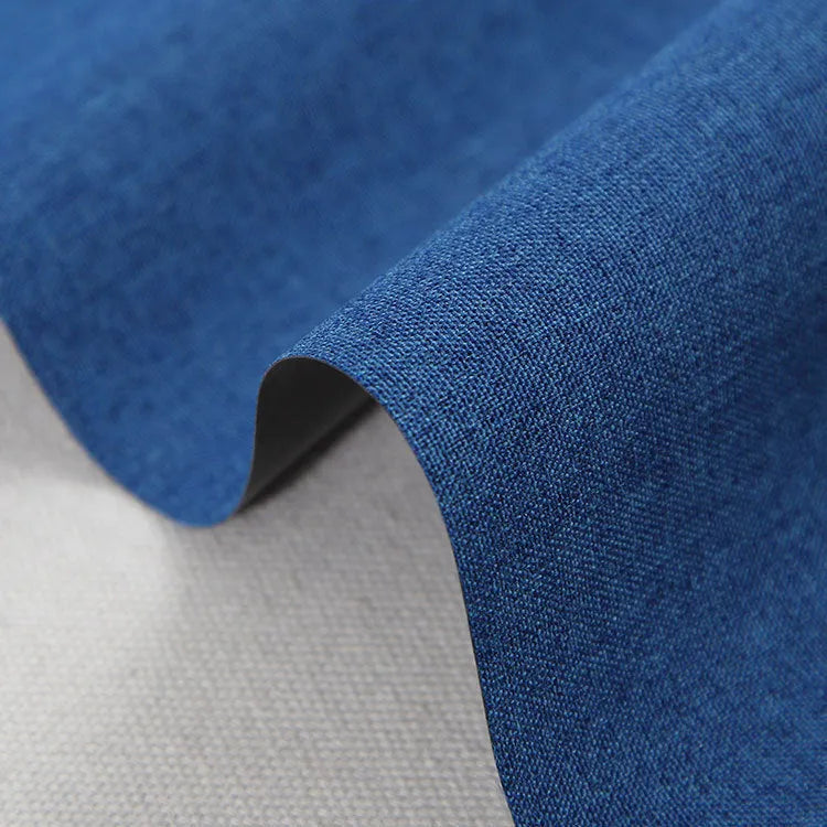 Roll of black polyester fabric with a white snowflake and dragon pattern, sold by the metre for covering projects.