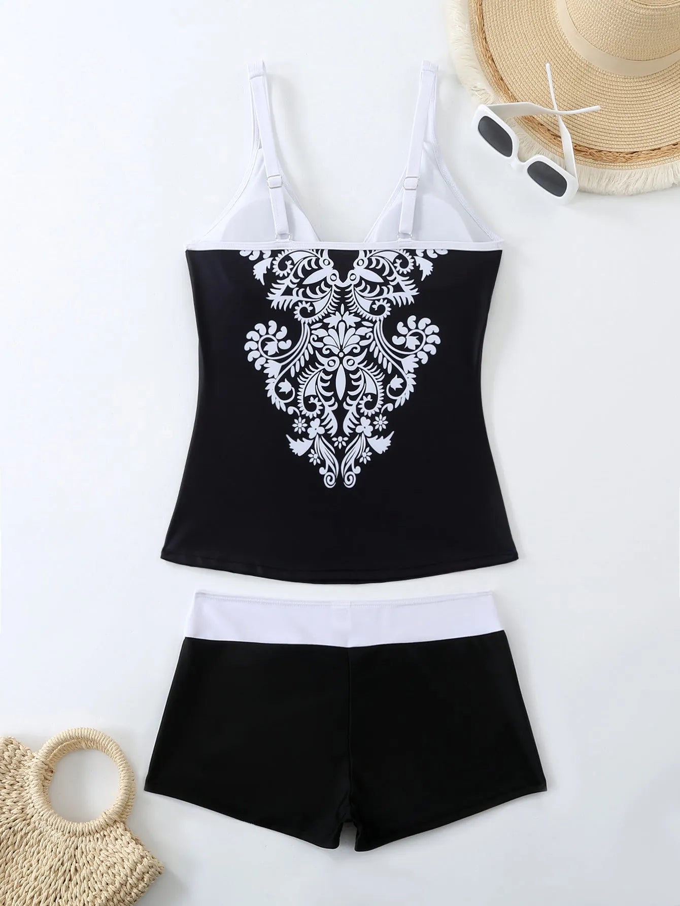 Women's plus size black and rose red two-piece swimsuit bikini set on a mannequin.
