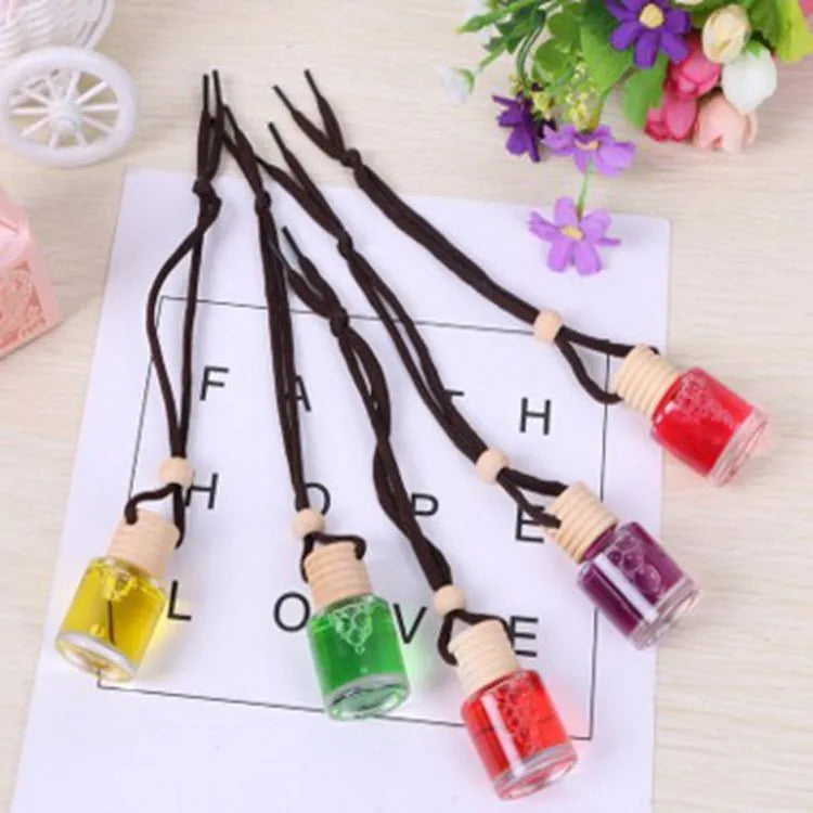 Glass bottle car air freshener hanging ornament with six fragrance refill options displayed