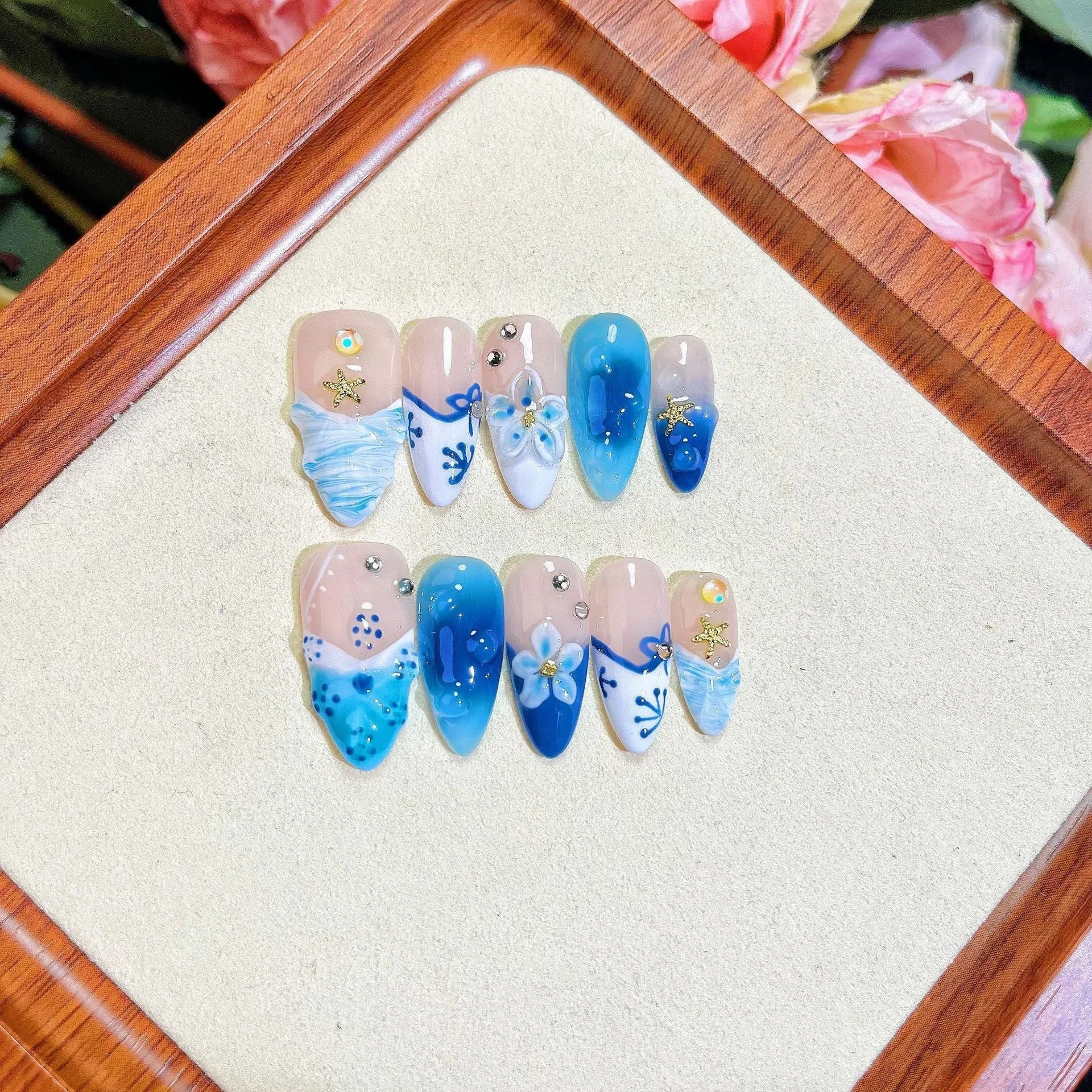 Set of hand-painted blue plastic fake nails with carved Summer Ice design in four sizes XS S M L