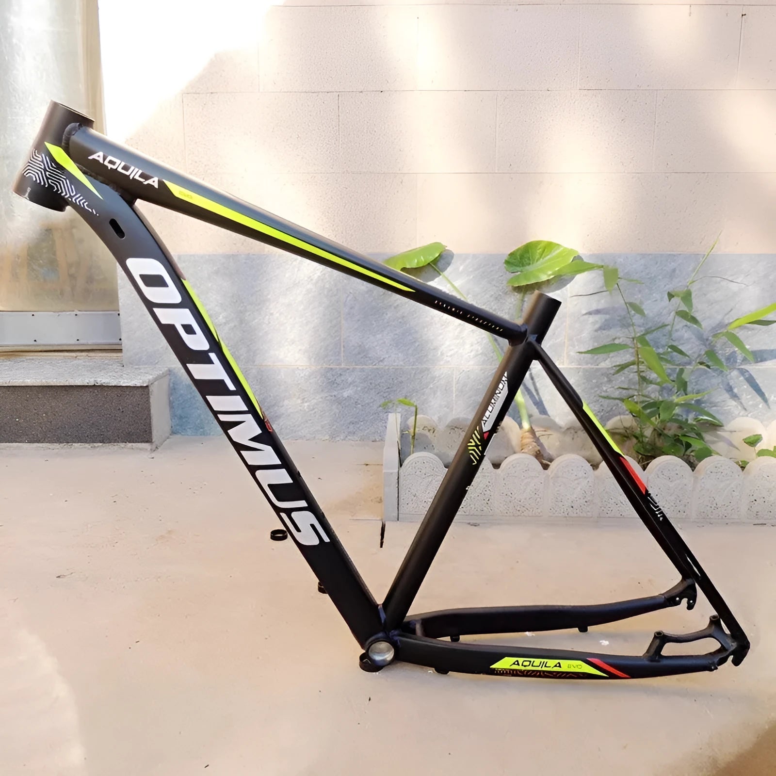 Black green 29-inch aluminium mountain bike frame with disc brake mounts and internal cable routing ports.