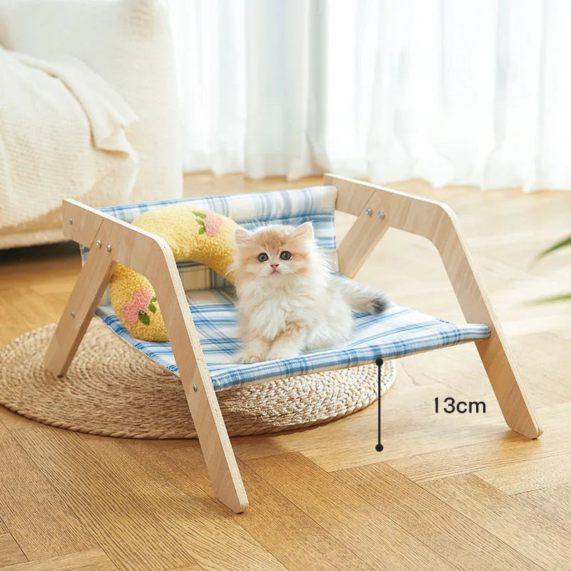 Wooden cat beach chair bed with blue cloth hammock suspended from frame