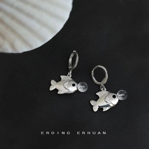 Copper electroplated bubble fish design earrings with goldfish animal modelling on a white background.