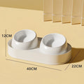 White elevated pet feeder with two tilted bowls on a wide base, for cats and small dogs.