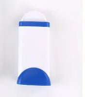 Blue reusable pet hair removal brush with self-cleaning base on a grey sofa.