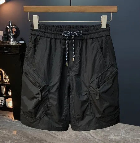 Man wearing loose-fit camouflage cargo shorts with cargo pockets and an elasticated waistband.