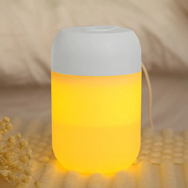 Small white cylindrical USB-powered humidifier with charging cable.