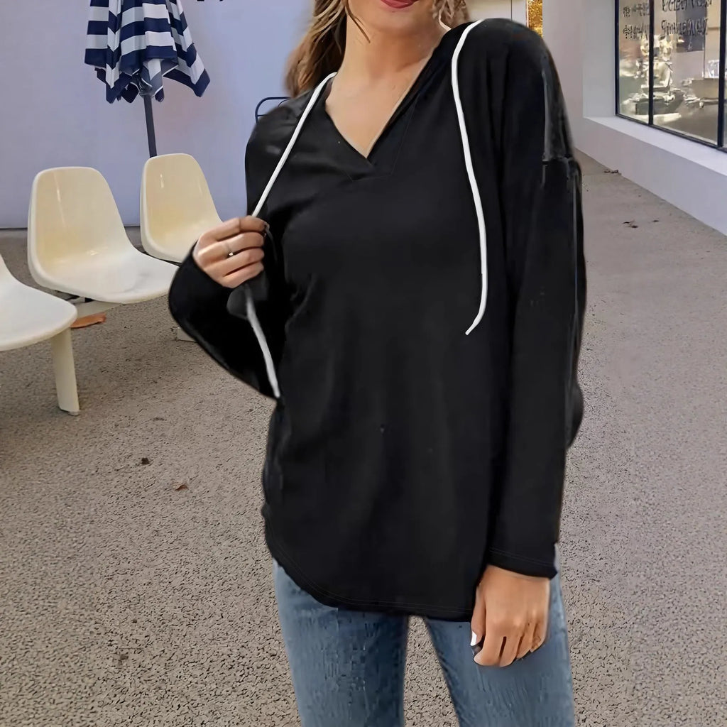 Red women's V-neck hooded sweatshirt with loose fit on a hanger, showing medium length.