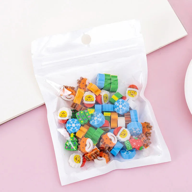 Sealed plastic bag containing 50 small cartoon-themed erasers in shapes like fruits, animals, and Christmas symbols.