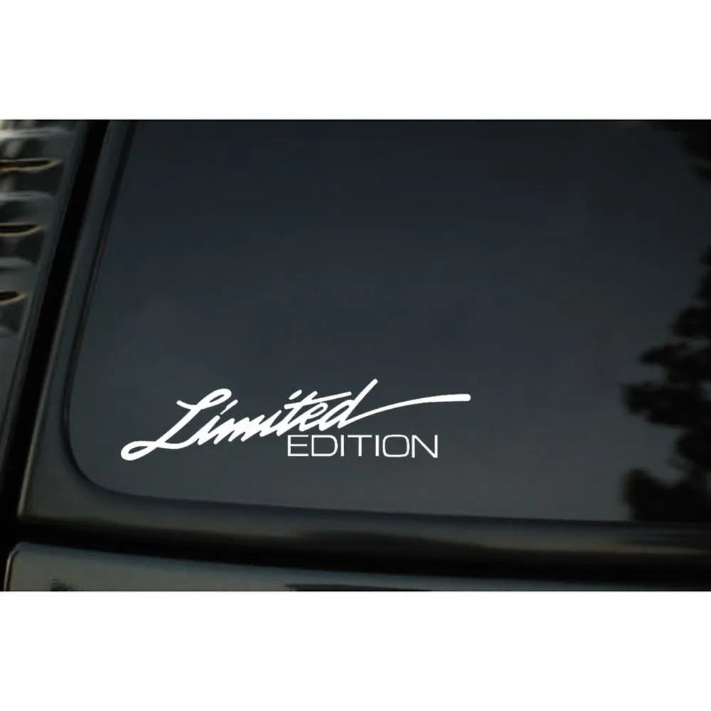 A reflective plastic bumper sticker measuring 16cm by 3.8cm, shown in black, white, and multicolour options.