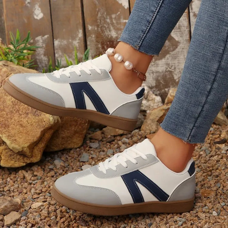 Blue women's low-top training shoes with rubber sole and front lace-up closure