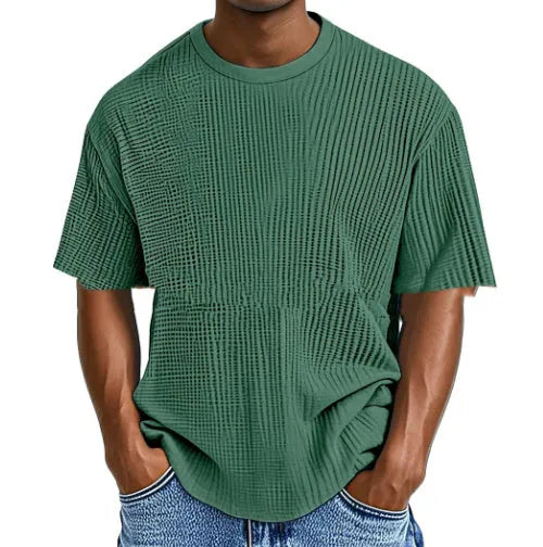 Man wearing a light blue waffle knit short sleeve cotton blend pullover, casual fit
