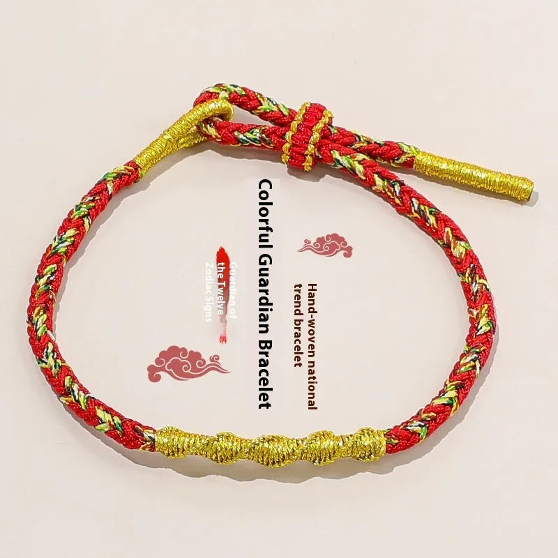 Close-up of an adjustable eight-strand woven hand strap in a zodiac-themed colour on a wrist.