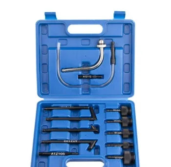 13-piece transmission oil refuelling kit showing injector tool and assorted connectors on a workbench