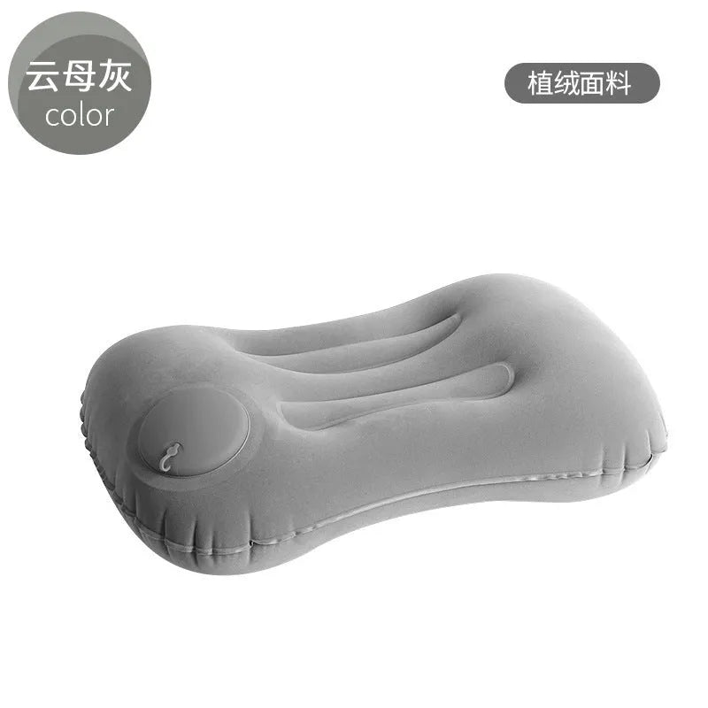 Grey press inflatable travel pillow showing size and flocking texture next to deflated state.