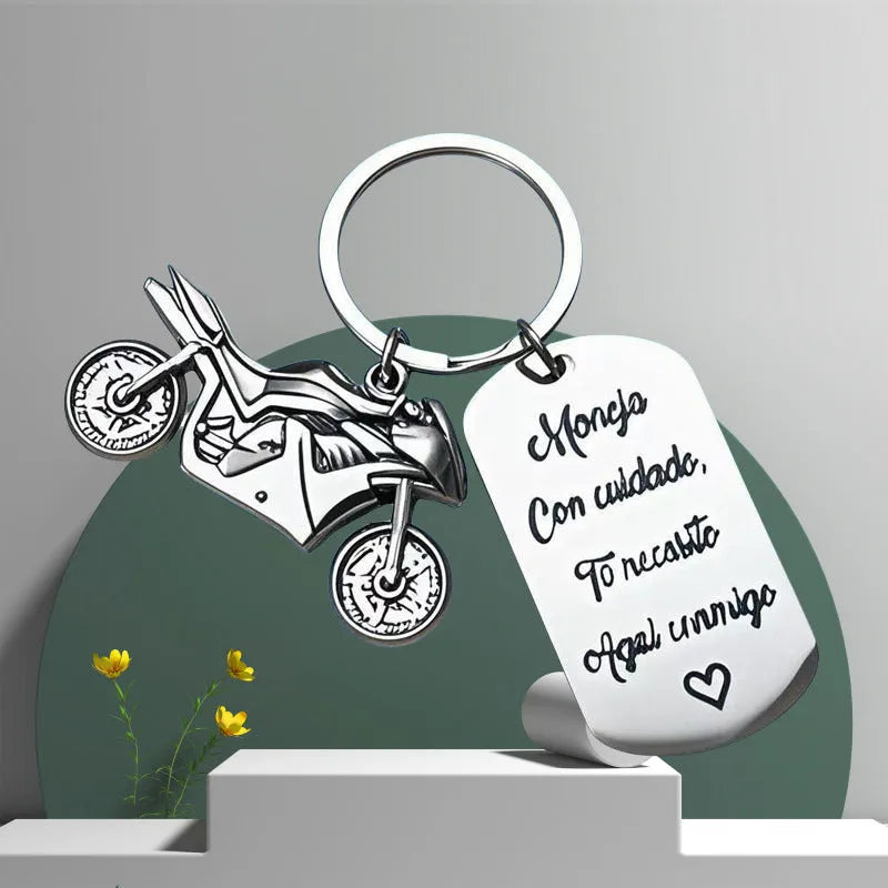 Stainless steel motorcycle-themed keychain with charm and a red flannel storage pouch.