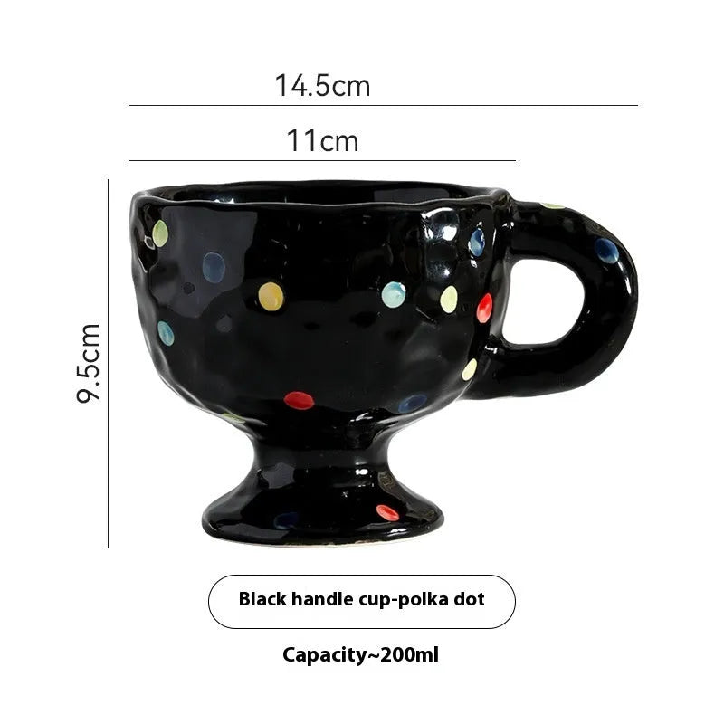 Handmade irregular solid colour ceramic mug on a table, showing its unique shape.