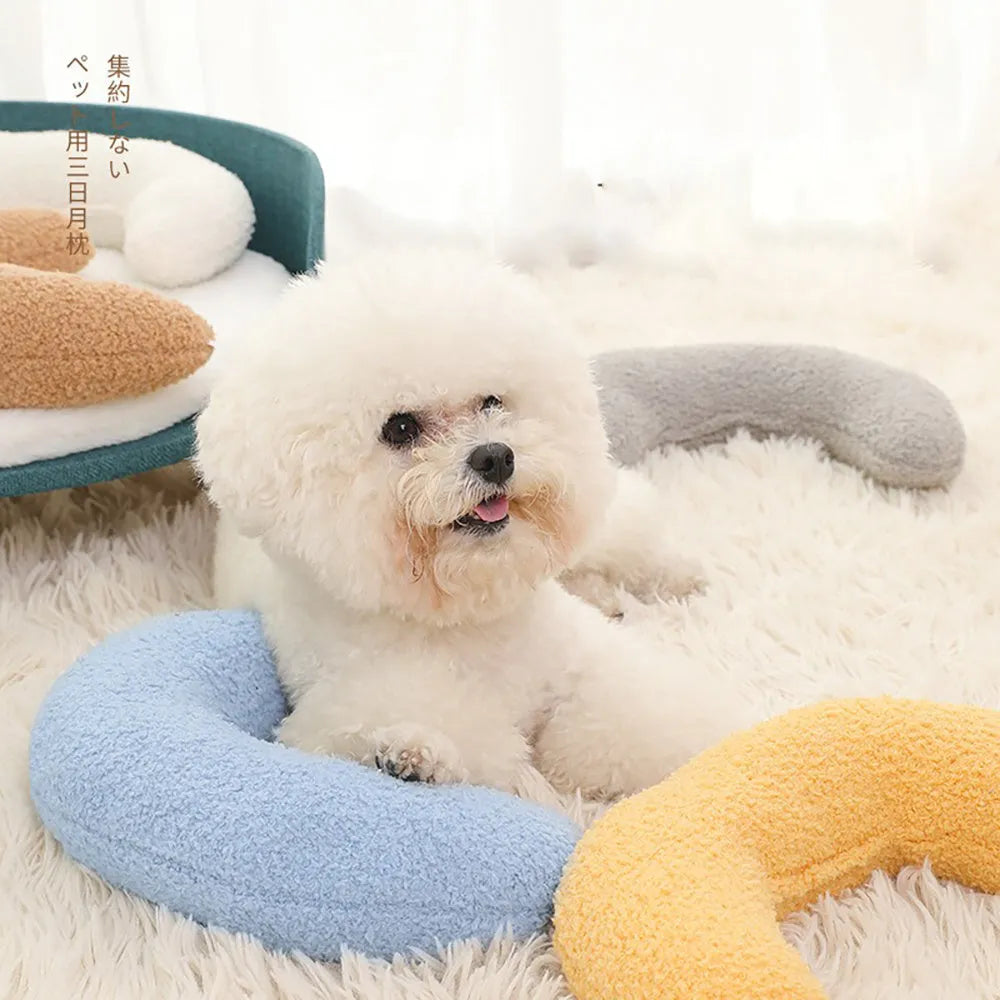 Blue U-shaped cat pillow with adjustable fabric collar on a sofa
