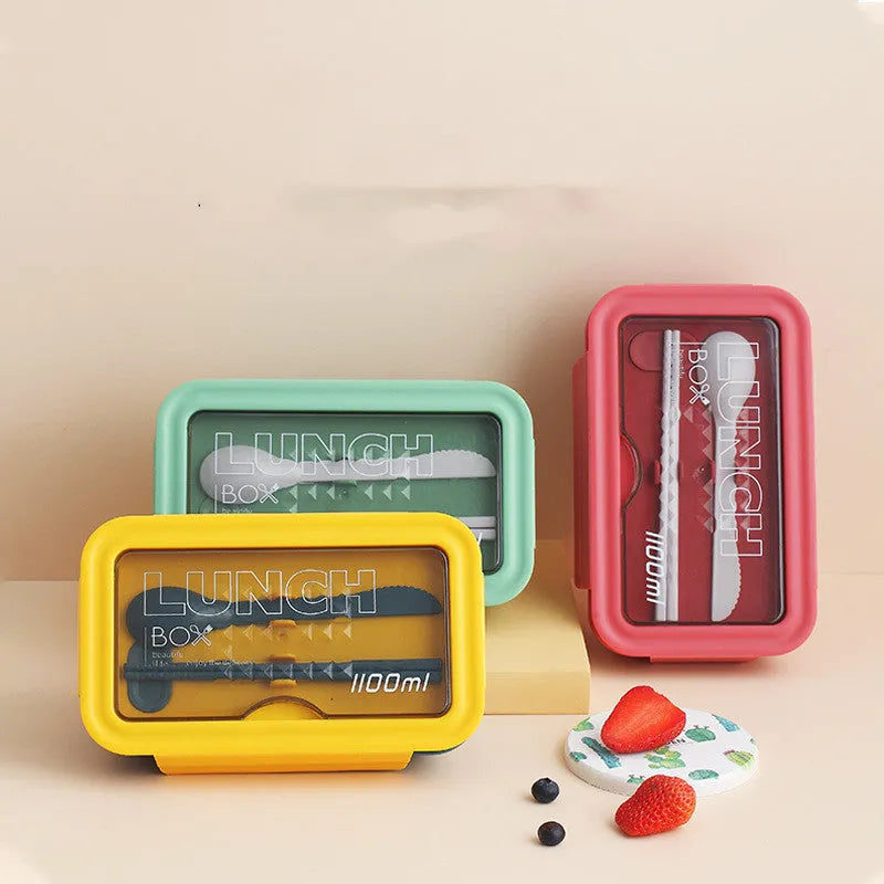 Green four-layer partitioned plastic bento lunch box with lid open.