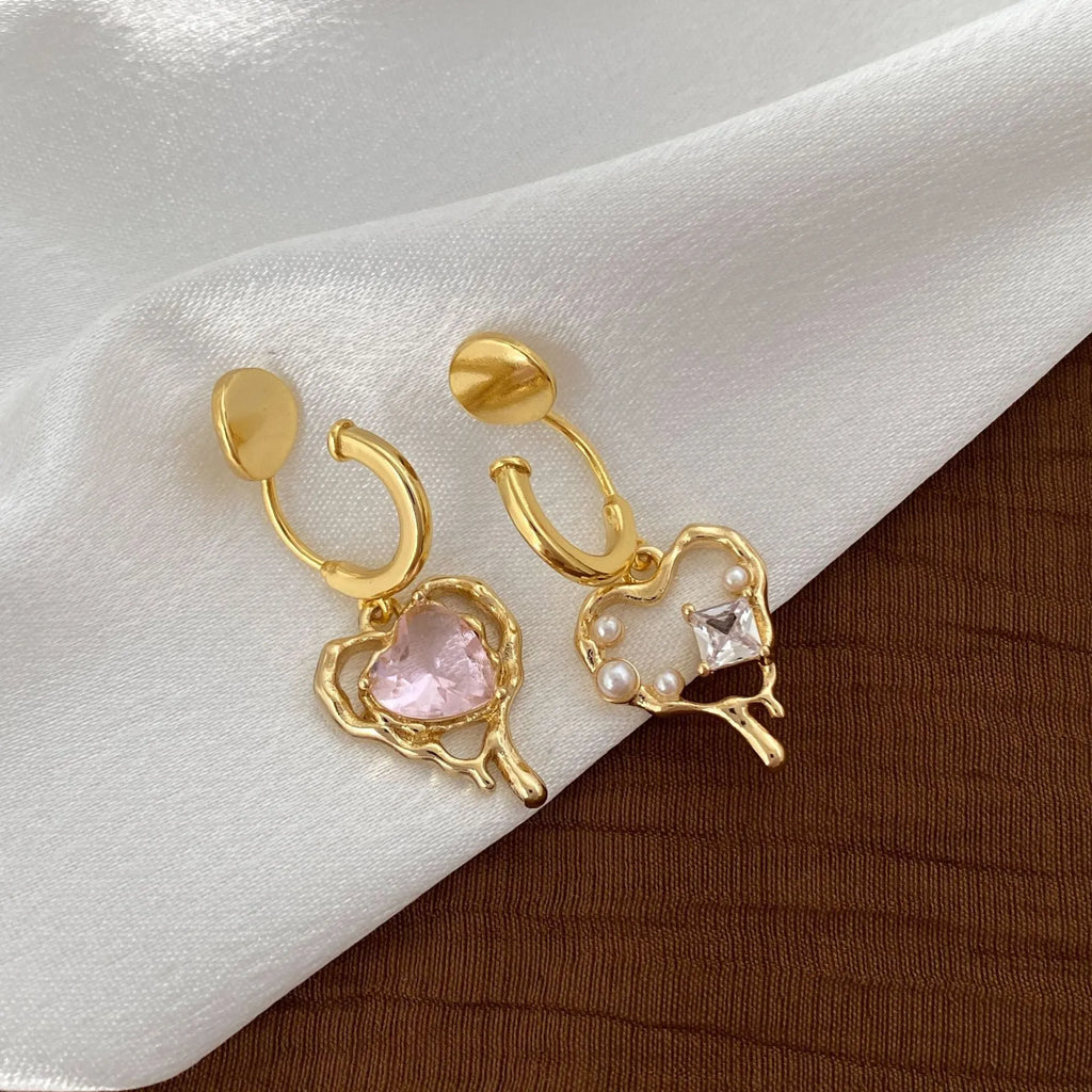 Asymmetric heart earrings with inlaid zircon on copper, available as ear clips or ear studs, one pair