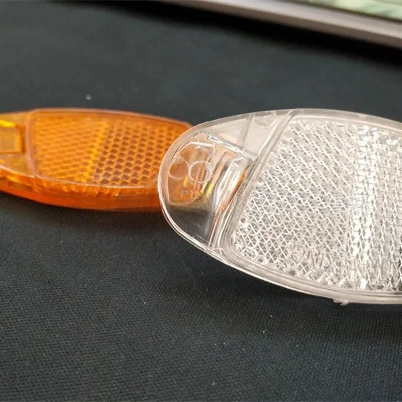 White and yellow plastic bicycle spoke reflectors for wheel safety decoration