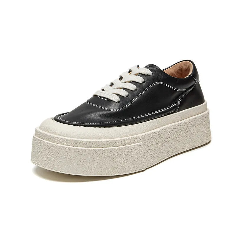 Women's black platform trainers with embossed leather upper and rubber sole