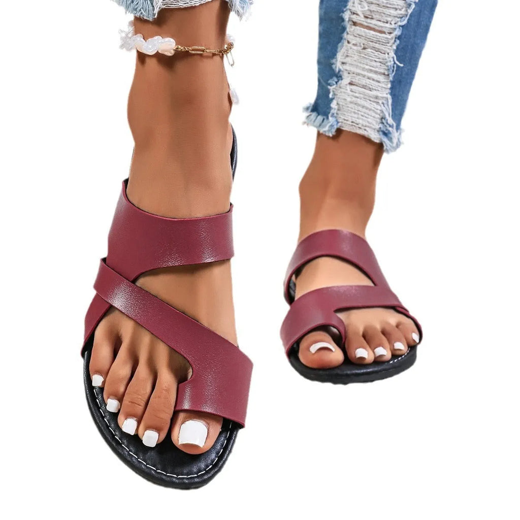 Adult round head beach slippers in black with hollow-out design and rubber sole.
