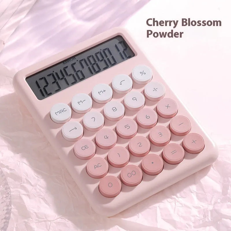 Gradient colour desktop calculator in violet, pink, blue, and green shades on a desk.