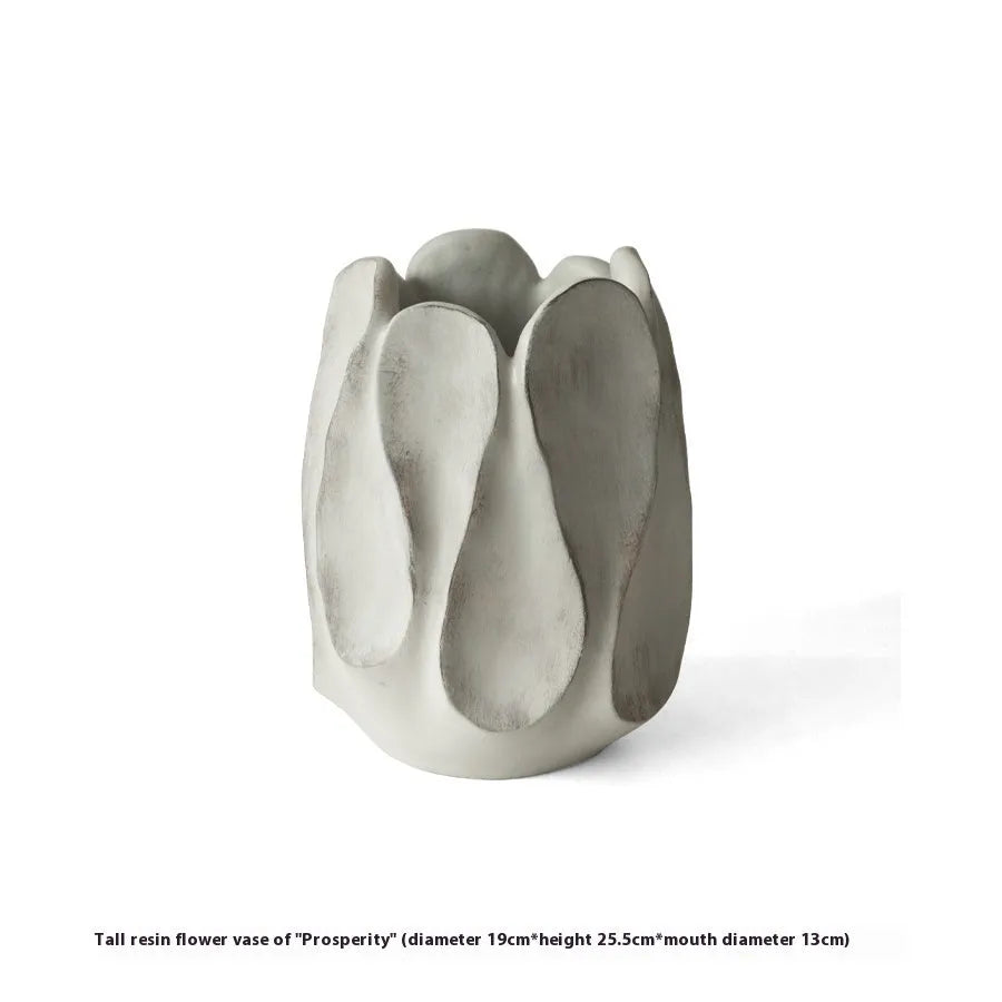 Irregular shaped ceramic art vase for flower arrangements on a desktop.