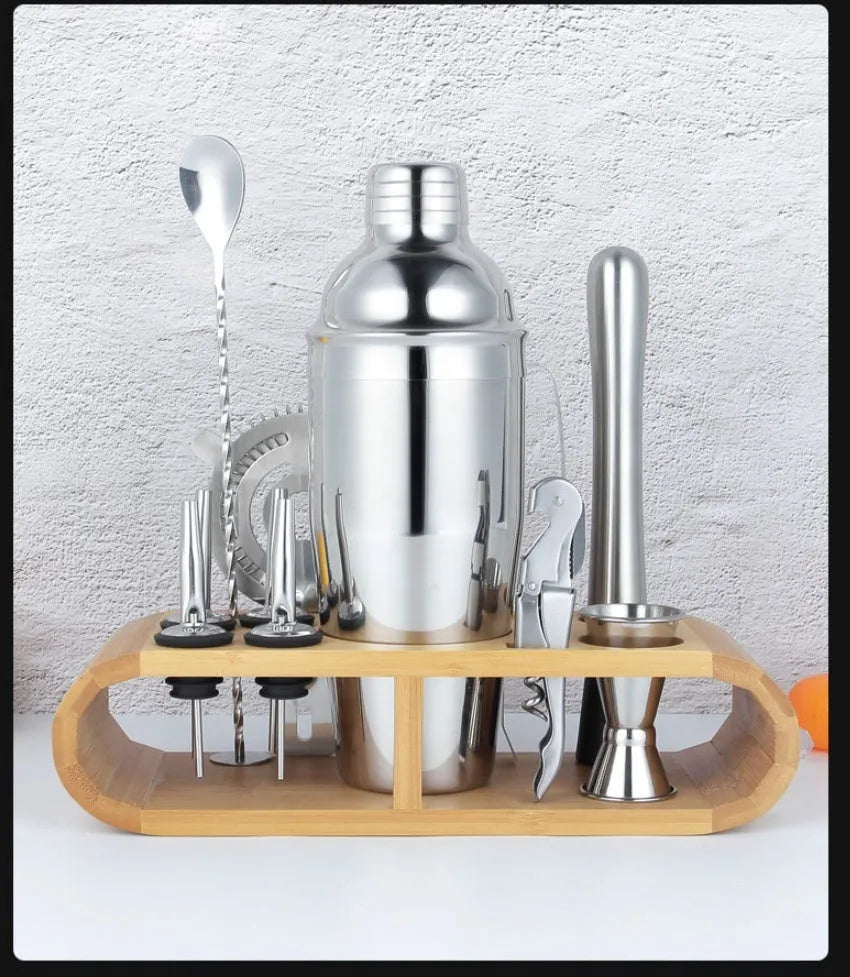 23-piece stainless steel and acrylic cocktail set with shakers, jiggers, and bar tools on a counter.