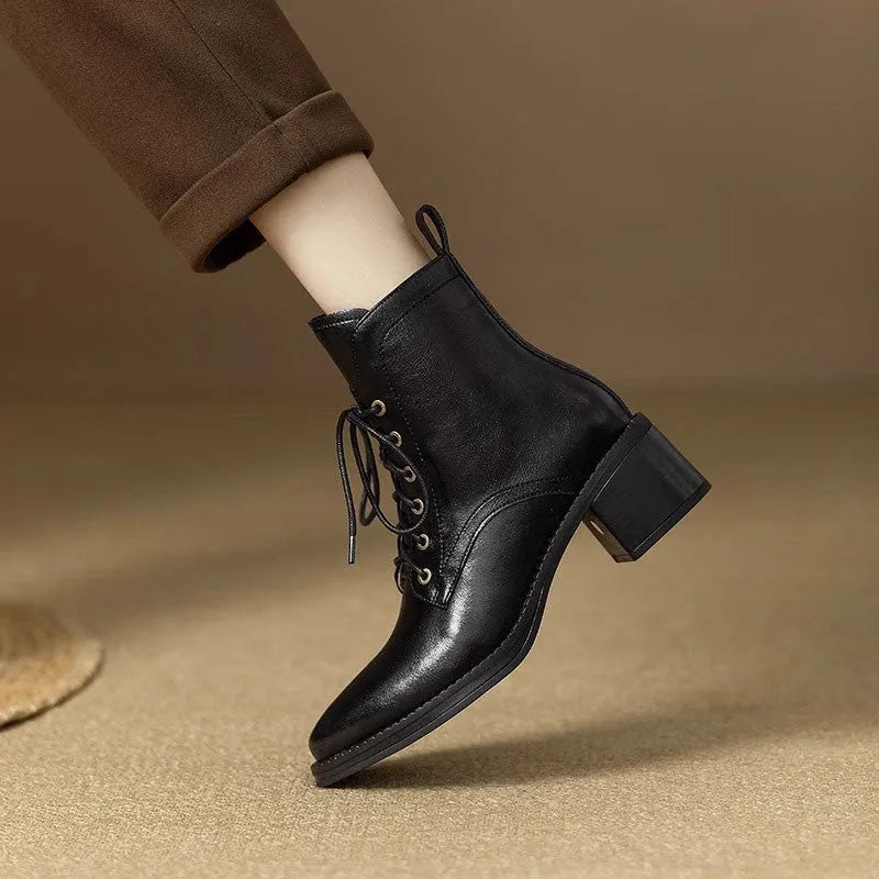 Women's black pointed-toe short boots with a 5.5cm heel and velvet finish on a neutral background.