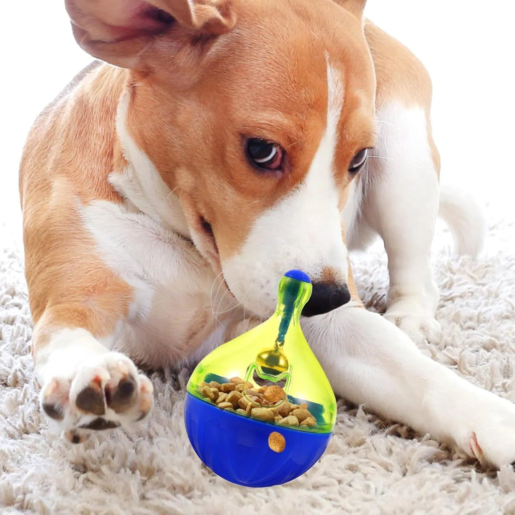 Blue and white tumbler-shaped pet treat dispenser toy on a wooden floor.