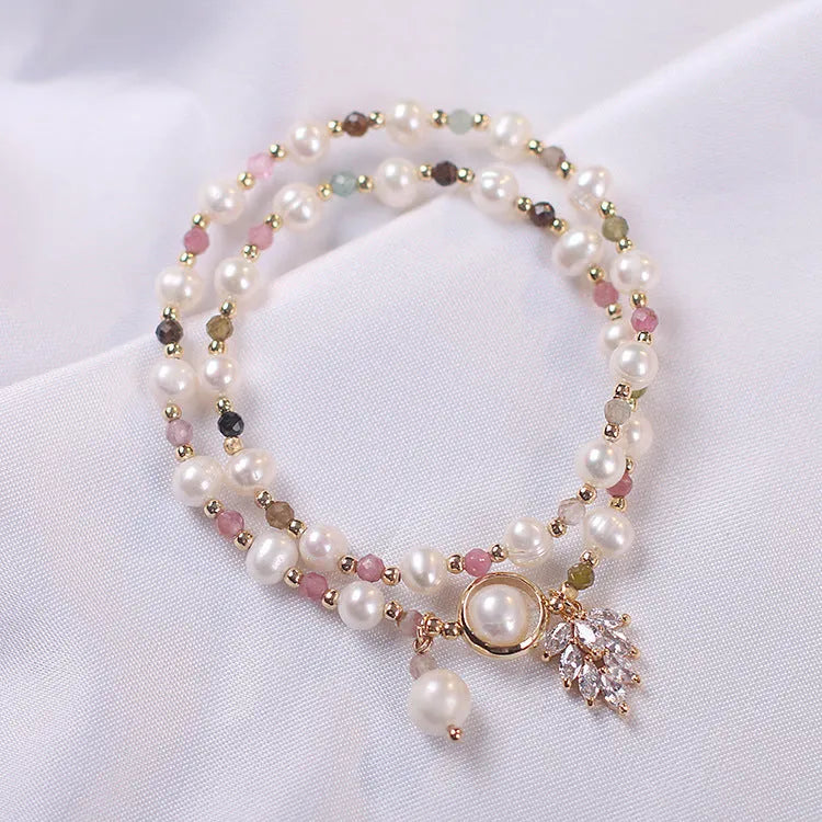 Women's double layer crystal bracelet with lucky cat charm and red cat's eye flowers in ethnic fairy style.