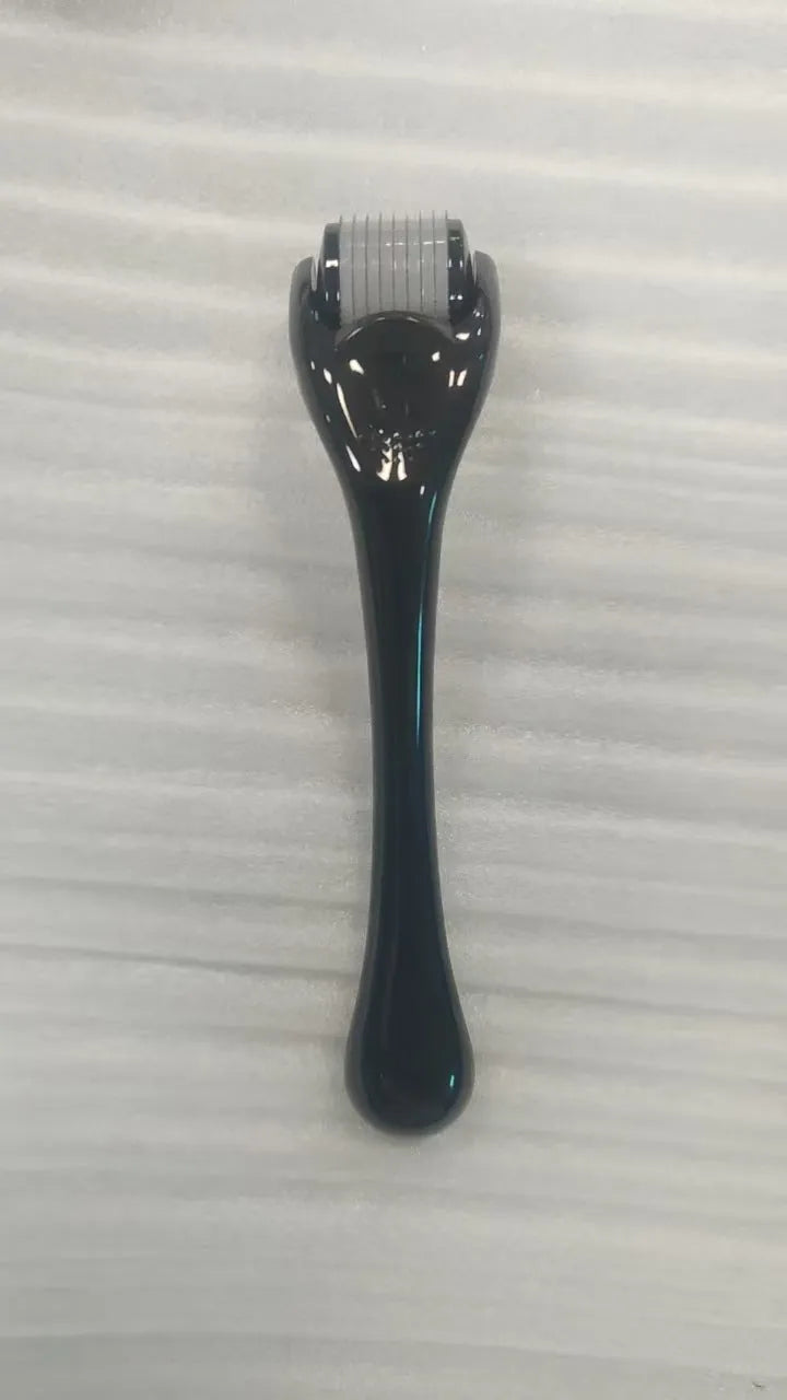 540 micro needle roller tool with black handle and coloured wheel on a white background.