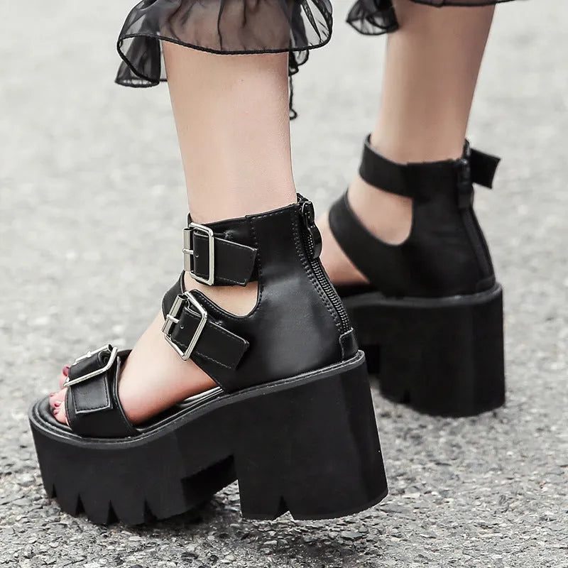 Black women's punk sandals with chunky thick heels, round toe, rear zipper, and a buckle detail.