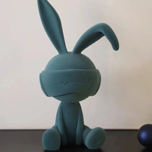 Green suede-finish resin ornament of a blindfolded rabbit for table decoration.