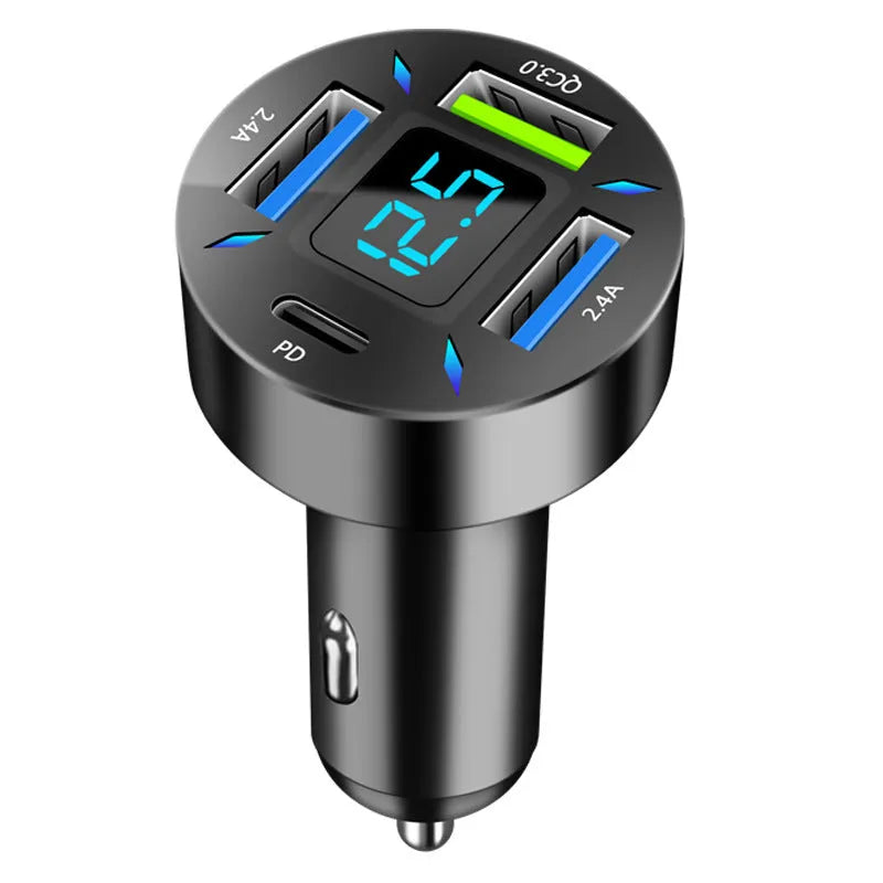 Black four-port USB car charger with LED voltage display plugged into a car socket.