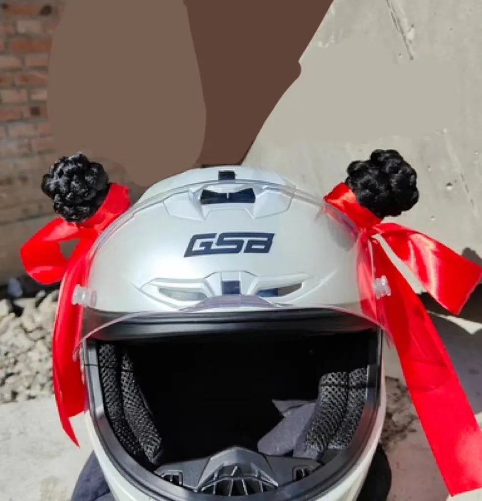Close-up of black skyhigh braid decorative balls attached to a motorcycle helmet, showing 8cm height