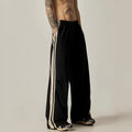 Black wide-leg straight-cut men's climbing trousers with a high waist on a hanger.
