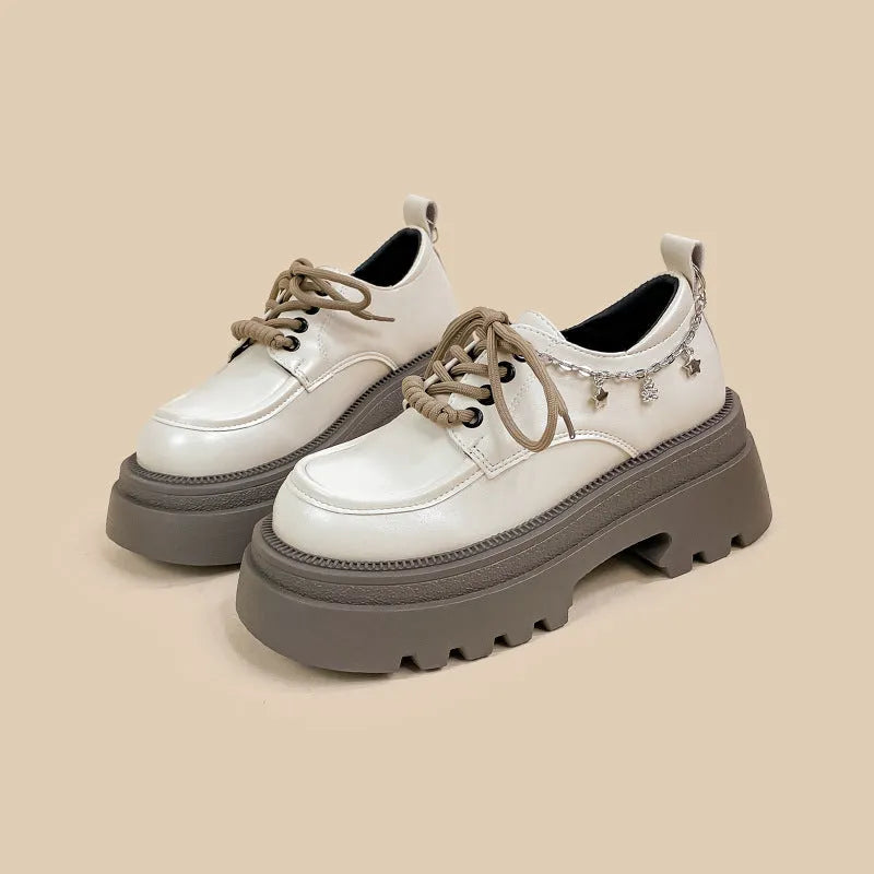 White platform Mary Jane shoes with a chunky block heel and front lace-up detail.